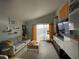 Spacious living room with large windows and sliding door access to balcony at 2516 Woodgate Blvd # 205, Orlando, FL 32822