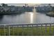 A view of the pond with a fountain surrounded by manicured lawns and community residences at 2516 Woodgate Blvd # 205, Orlando, FL 32822