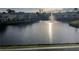 A view of the pond with a fountain surrounded by manicured lawns and community residences at 2516 Woodgate Blvd # 205, Orlando, FL 32822