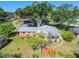 Aerial view of a well-maintained home with a metal roof and mature trees at 2640 Handley Blvd, Lakeland, FL 33803