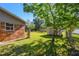 View of the backyard of the home featuring the red brick exterior at 2640 Handley Blvd, Lakeland, FL 33803