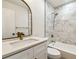 Modern bathroom featuring a stylish vanity, a mirror, and a shower with marble-look tile at 2640 Handley Blvd, Lakeland, FL 33803