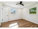 A bright bedroom featuring wood floors and two windows providing natural light at 2640 Handley Blvd, Lakeland, FL 33803