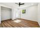 Bedroom featuring wood floors, an open closet, and a window for natural light at 2640 Handley Blvd, Lakeland, FL 33803