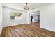 Bright dining area featuring wood floors and a modern light fixture adjacent to the kitchen at 2640 Handley Blvd, Lakeland, FL 33803