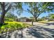 Charming home with two-car garage, red door, and mature trees at 2640 Handley Blvd, Lakeland, FL 33803