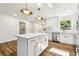 Kitchen island with white cabinets and quartz countertops, stainless steel appliances, and modern lighting at 2640 Handley Blvd, Lakeland, FL 33803
