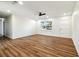 Well-lit living room with wood flooring, a ceiling fan, and a view of the neighborhood at 2640 Handley Blvd, Lakeland, FL 33803