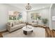 Bright living room featuring wood floors, natural light, neutral colors, and stylish decor at 2640 Handley Blvd, Lakeland, FL 33803