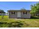 Backyard storage shed with a white door and two windows at 2640 Handley Blvd, Lakeland, FL 33803