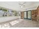 Bright sunroom with tiled flooring, brick walls and multiple windows providing natural light at 2640 Handley Blvd, Lakeland, FL 33803