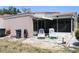 Home's backyard featuring lounge chairs and an enclosed patio at 266 Las Flores, Winter Haven, FL 33884
