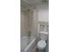 Bathroom featuring a bathtub-shower combo, with coordinating neutral tiles and fixtures for a fresh and clean appearance at 266 Las Flores, Winter Haven, FL 33884