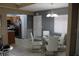 Dining area featuring a glass table, white chairs, and a view of the kitchen at 266 Las Flores, Winter Haven, FL 33884