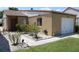 Charming single-story home showing a well-manicured lawn, colorful plants, and one car garage at 266 Las Flores, Winter Haven, FL 33884