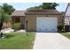 Charming single-story home with a well-manicured lawn, mature plants and a one car garage at 266 Las Flores, Winter Haven, FL 33884