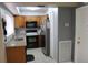 Well-maintained kitchen with stainless steel appliances and warm wooden cabinetry at 266 Las Flores, Winter Haven, FL 33884