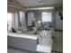 Open living area with tile floors flows into the dining room with patio doors at 266 Las Flores, Winter Haven, FL 33884