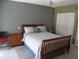 Bedroom featuring a wood-framed bed, neutral decor, and ample closet space, creating a cozy and inviting atmosphere at 266 Las Flores, Winter Haven, FL 33884