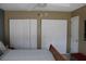 Bedroom with a wooden bed frame, complemented by closet doors, and a view of the en-suite bathroom, enhancing functionality at 266 Las Flores, Winter Haven, FL 33884
