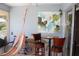 Enclosed patio with abstract art, chairs, table and bicycle at 266 Las Flores, Winter Haven, FL 33884