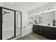 Modern bathroom with a glass-enclosed shower, soaking tub, and double vanity sinks at 287 Lake Smart Cir, Winter Haven, FL 33881