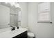 Bright bathroom featuring a shower with curtain, toilet, and vanity with modern fixtures at 287 Lake Smart Cir, Winter Haven, FL 33881