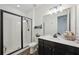 Well-lit bathroom featuring a glass-enclosed shower and vanity with ample counter space for a refreshing experience at 287 Lake Smart Cir, Winter Haven, FL 33881