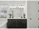 Modern bathroom featuring double vanity, sleek fixtures, and a glass-enclosed shower for a luxurious spa-like experience at 287 Lake Smart Cir, Winter Haven, FL 33881