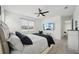 Modern bedroom features a tufted headboard, television, and ceiling fan for added comfort at 287 Lake Smart Cir, Winter Haven, FL 33881