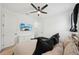Serene bedroom featuring a ceiling fan, TV, and a plush bed, creating a relaxing atmosphere for rest and rejuvenation at 287 Lake Smart Cir, Winter Haven, FL 33881