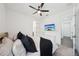 Inviting bedroom featuring a ceiling fan, TV, and a comfortable bed, creating a relaxing space for rest and relaxation at 287 Lake Smart Cir, Winter Haven, FL 33881