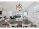 Dining area with a wooden table, white chairs, and modern lighting fixture at 287 Lake Smart Cir, Winter Haven, FL 33881