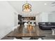 Bright, open-concept dining area featuring a large wooden table and a view of the modern kitchen at 287 Lake Smart Cir, Winter Haven, FL 33881