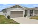 Charming single-story home featuring a 2-car garage and well-kept lawn with minimal landscaping at 287 Lake Smart Cir, Winter Haven, FL 33881