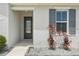 Close-up of the front entrance featuring a decorative glass door and attractive landscaping at 287 Lake Smart Cir, Winter Haven, FL 33881