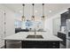 Modern kitchen island with stainless steel appliances and pendant lighting at 287 Lake Smart Cir, Winter Haven, FL 33881