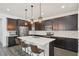 Contemporary kitchen featuring dark cabinetry, stainless steel appliances, and a center island with seating at 287 Lake Smart Cir, Winter Haven, FL 33881