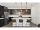 Modern kitchen with stainless steel appliances, dark cabinets, white countertop island, and pendant lighting at 287 Lake Smart Cir, Winter Haven, FL 33881