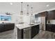 Modern kitchen with stainless appliances, a center island, and an open layout to the living area at 287 Lake Smart Cir, Winter Haven, FL 33881