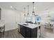 Modern open kitchen with a center island and views into the dining and living spaces at 287 Lake Smart Cir, Winter Haven, FL 33881
