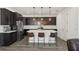 Bright kitchen features stainless steel appliances, dark cabinetry, white countertops, and modern pendant lighting at 287 Lake Smart Cir, Winter Haven, FL 33881