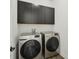 Modern laundry room featuring front-load washer and dryer, with ample storage space and sleek design at 287 Lake Smart Cir, Winter Haven, FL 33881
