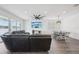 Open-concept living room featuring dining area, large sectional couch and TV at 287 Lake Smart Cir, Winter Haven, FL 33881