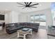 Open-concept living room with modern furnishings, ceiling fan, and large sliding glass doors at 287 Lake Smart Cir, Winter Haven, FL 33881