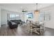 Open-concept living room with modern fan, dining area, and sliding glass doors at 287 Lake Smart Cir, Winter Haven, FL 33881