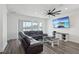 Bright living room with sectional seating, a ceiling fan, and sliding glass doors at 287 Lake Smart Cir, Winter Haven, FL 33881