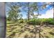 Lush backyard with mature trees offering shade and privacy at 2960 Kokomo Loop, Haines City, FL 33844