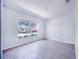Bright bedroom featuring tile flooring and a large window showcasing a vibrant outdoor view at 2960 Kokomo Loop, Haines City, FL 33844