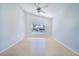 Empty bedroom featuring neutral paint, a ceiling fan, and an exterior view at 2960 Kokomo Loop, Haines City, FL 33844